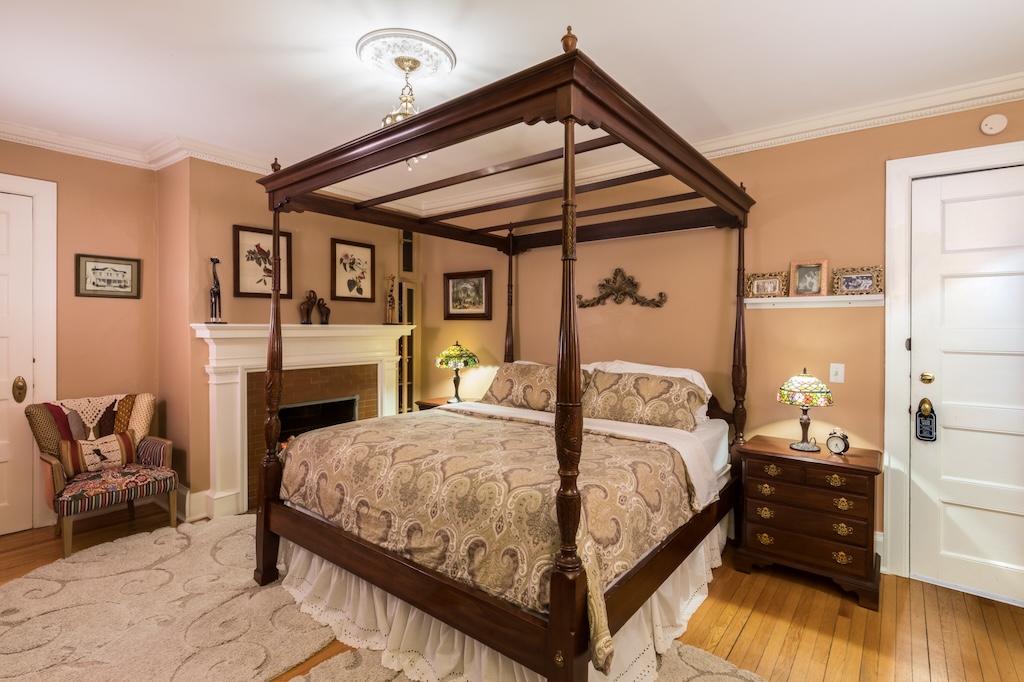 four-poster bed and fireplace in a bed-and-breakfast