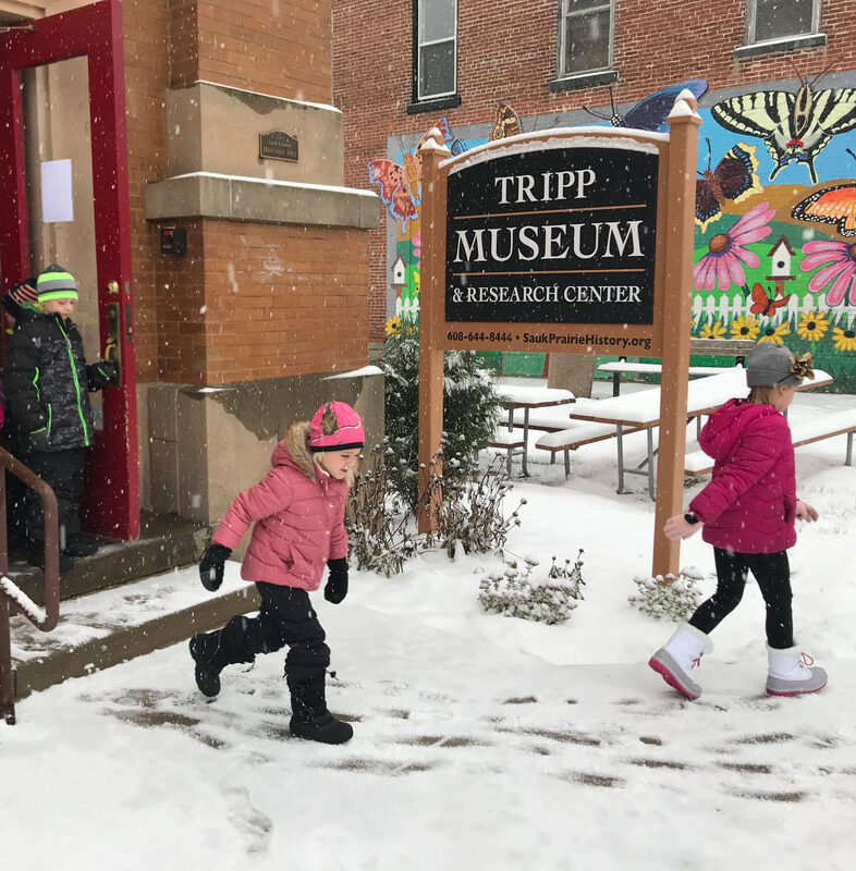 children walking in the snow outside the Tripp Museum