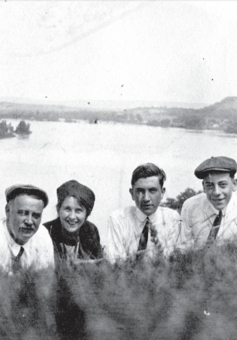historical photo of three men and a women in front of Sauk River