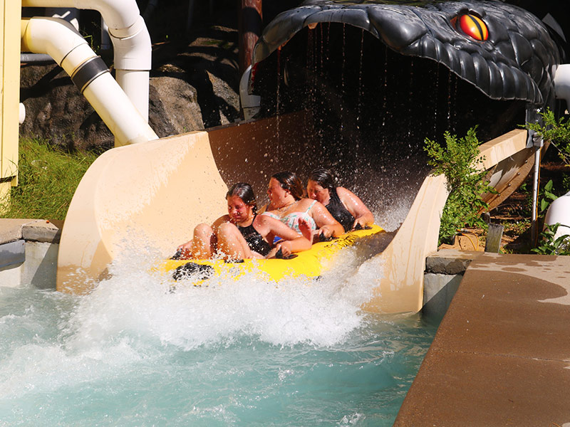 group of three girls riding a water slide