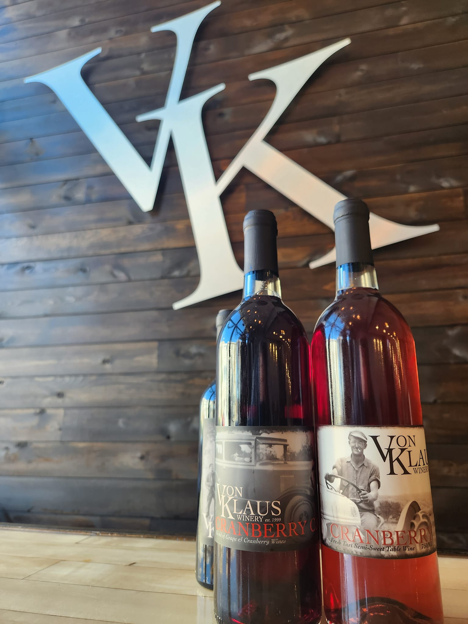 bottles of wine in front of Von Klaus Winery logo