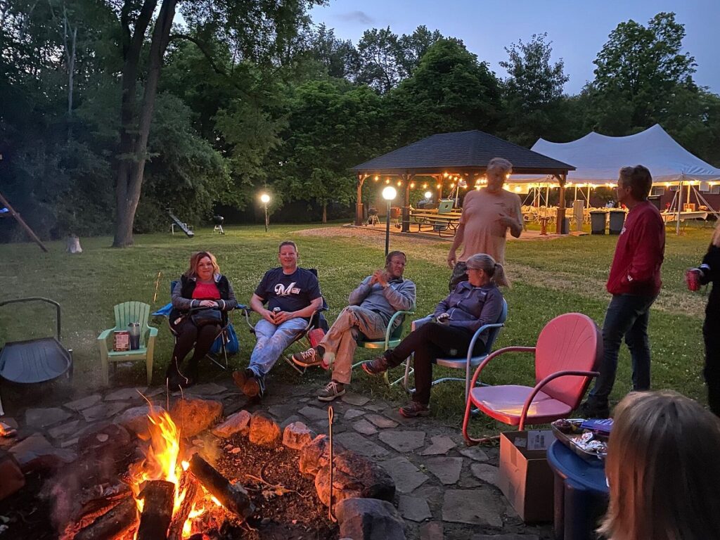 People sitting around campfire at Willowood Inn in Sauk County, Wisconsin