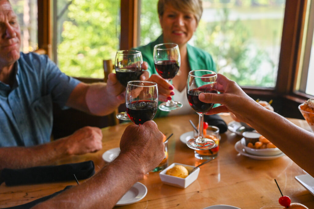 Couple toasting with red wine at Ishnala Supper Club in Sauk County, Wisconsin